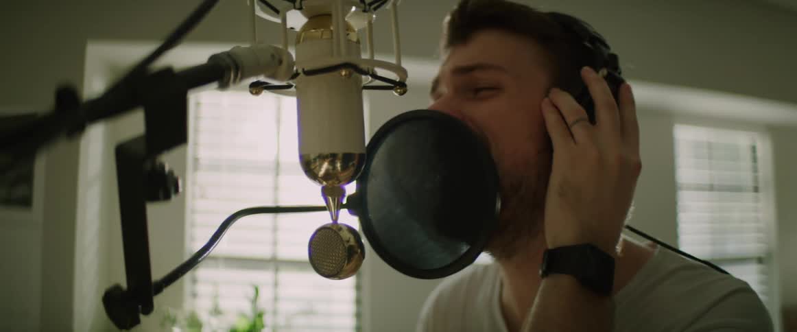 A man is singing in a room