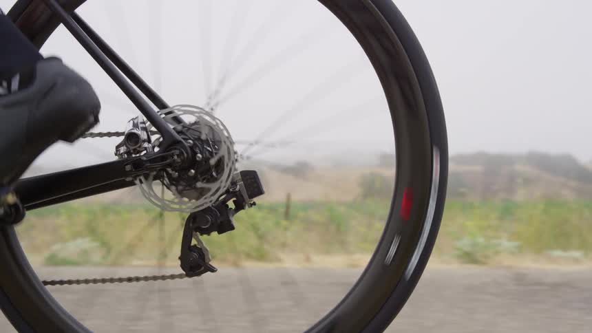 Bicycle wheel spinning along a country road