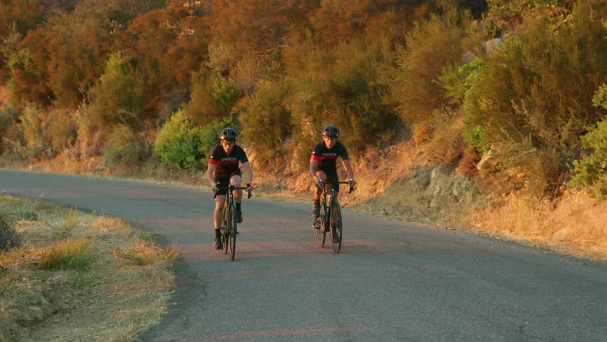Cyclist riding their bikes up a mountain road