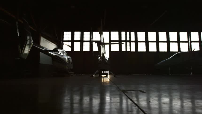 Helicopters are parked in an airport hangar