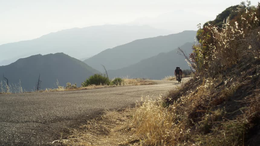 Two people ride their bike on the trail