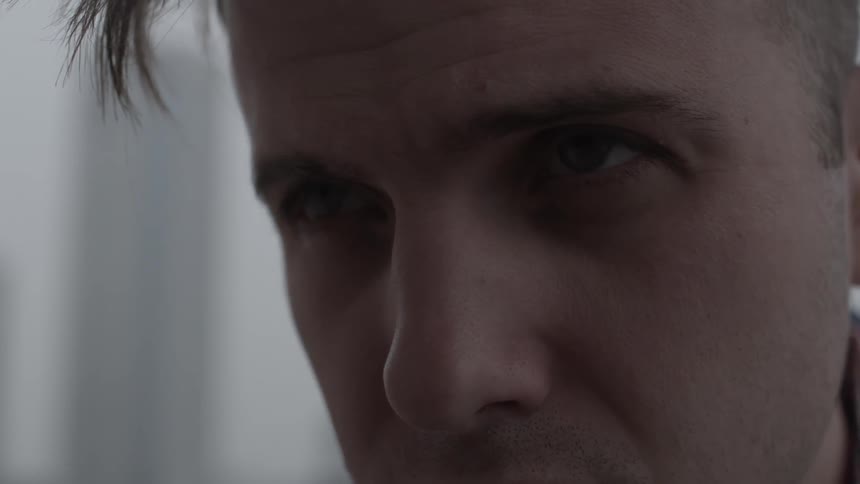 A man slowly looks up on a cloudy day