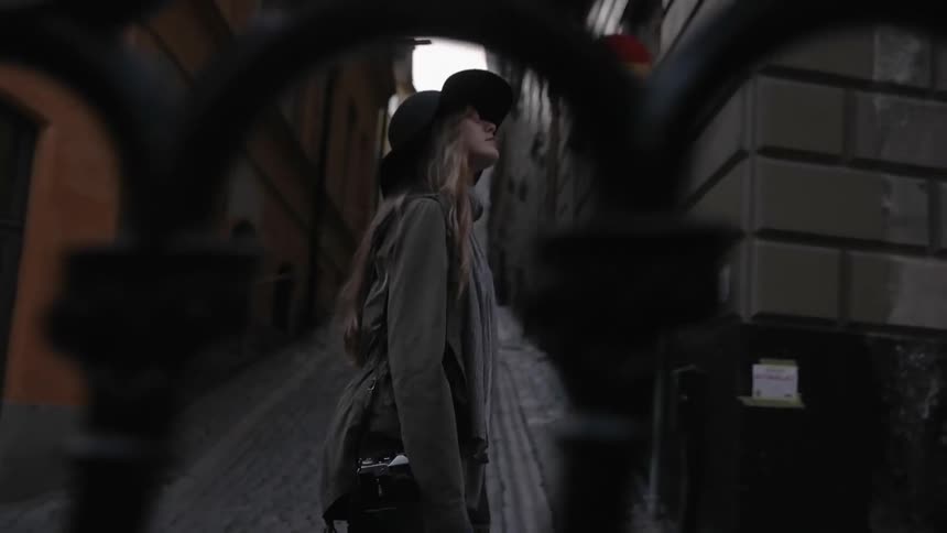 A woman is traveling down a city street on a cloudy day
