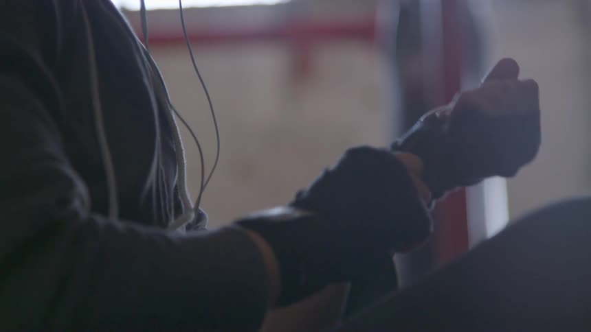 A boxer wraps her hands