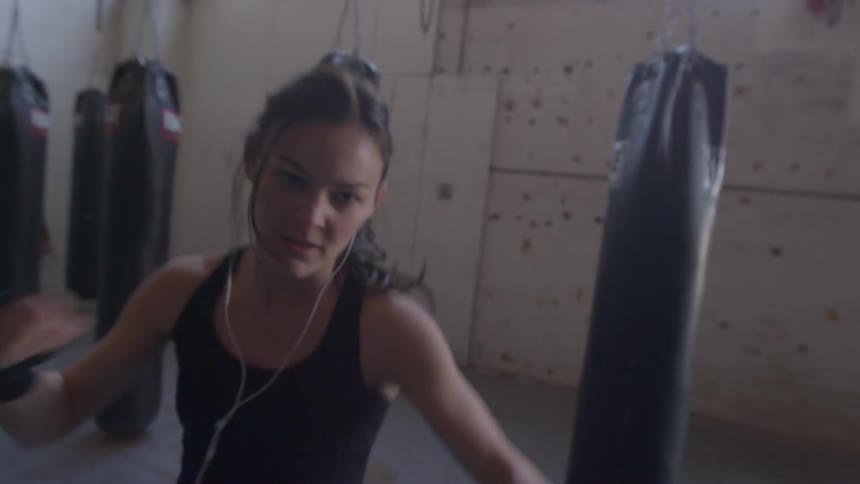 A woman is boxing indoors