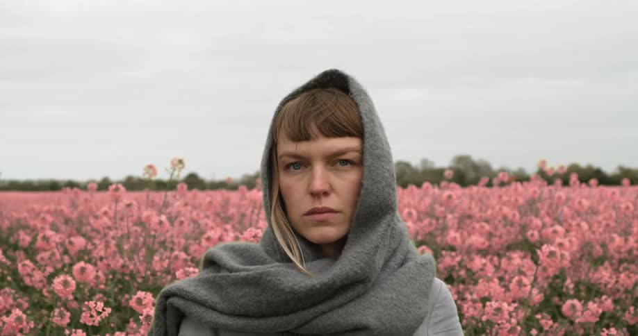 A woman is standing in a flower meadow
