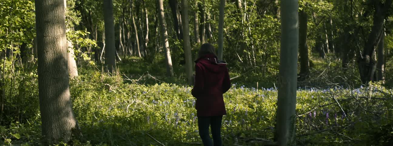 A woman standing in a forest