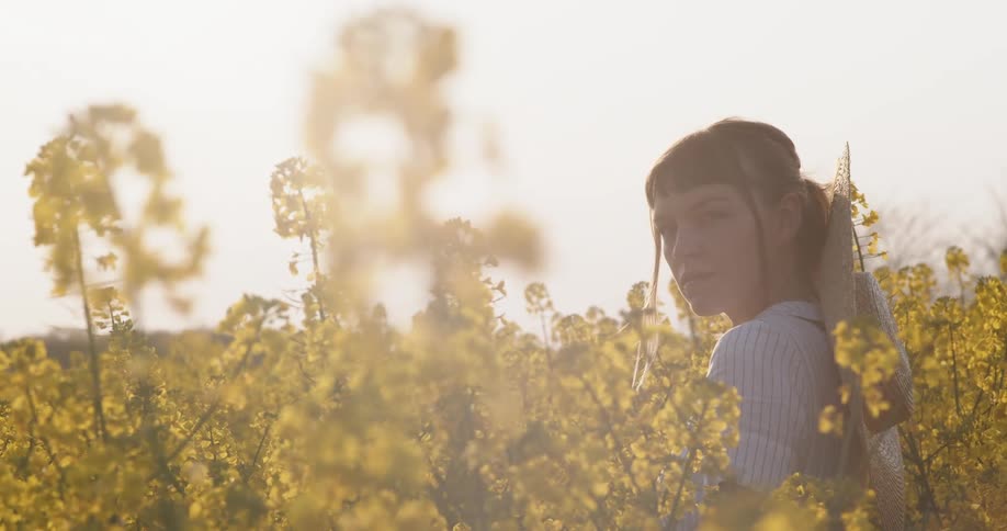 A woman is standing in a flower meadow