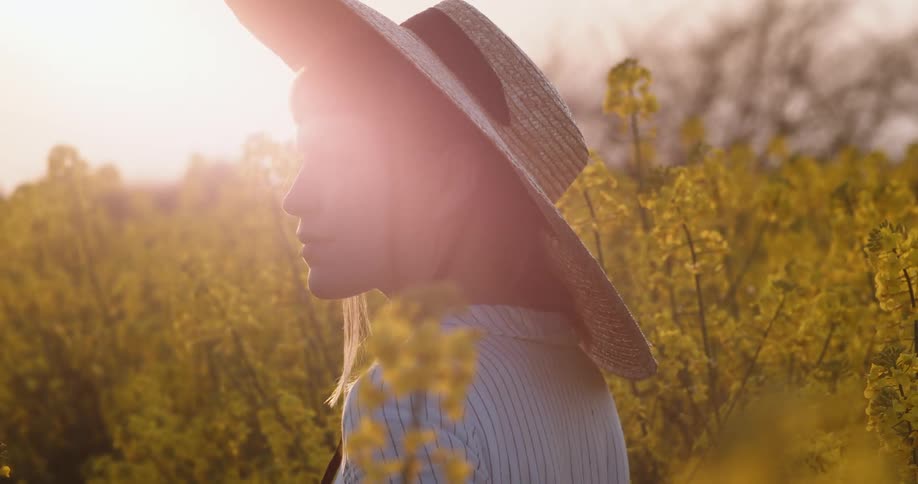 A teenager stands in a field of flowers