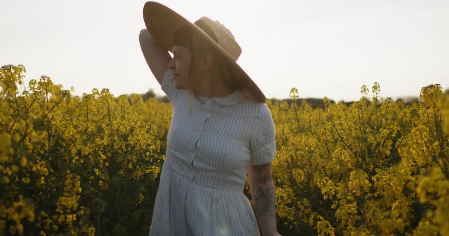 A young female runs through a field of flowers