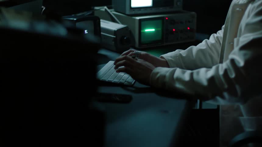 A man is typing fast on the keyboard