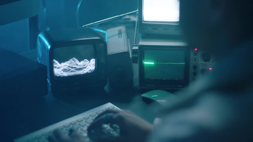 A person is typing on the keyboard on the desk
