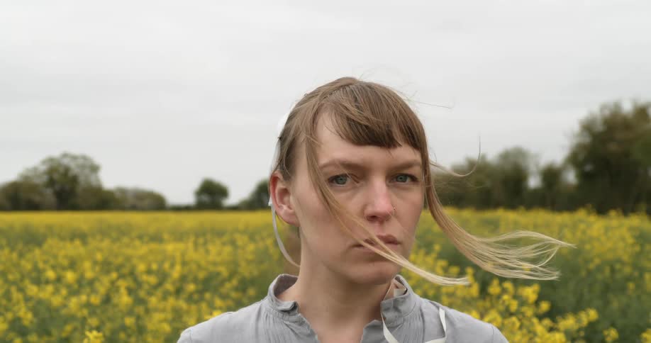 A woman is standing in a flower meadow