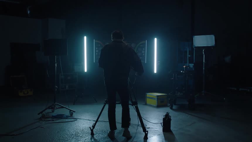 A man walks over to the camera to film the stage