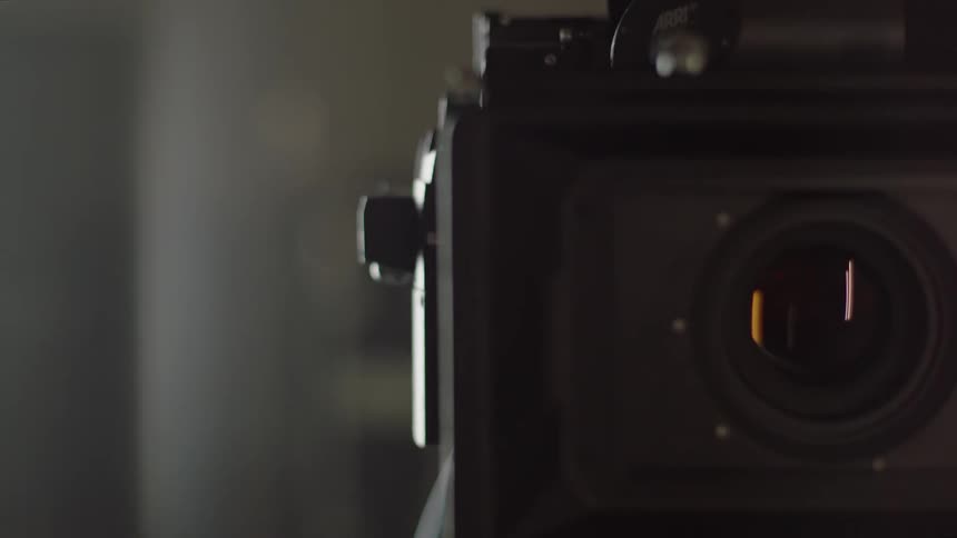 Close up of the lens of a camera on a tripod