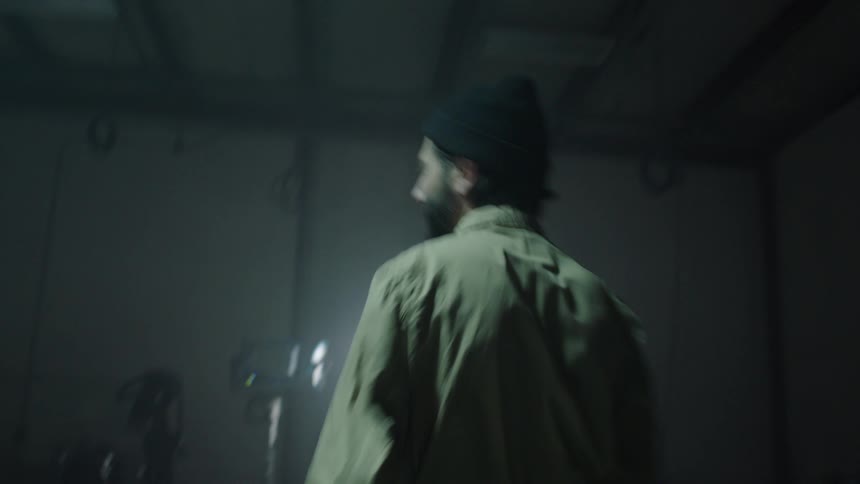 Time lapse of a man walking around a studio with audio equipment