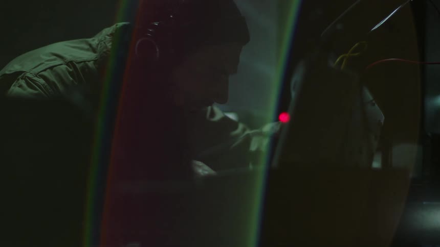 A man leans over and presses a button on the machine