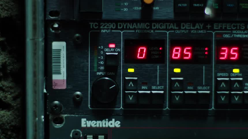 Red digital numbers blink and fade on a piece of electronic equipment