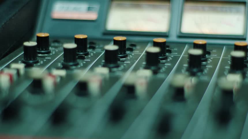 A musical mixer with knobs slides and buttons