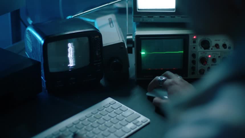 A security guard uses a computer as a portable television and screen flash around her