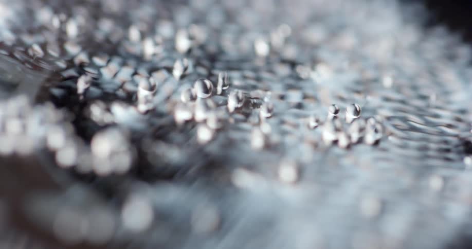 Vibrations cause water to splash and droplets to form