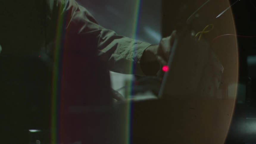 A man is turning switches on the machine