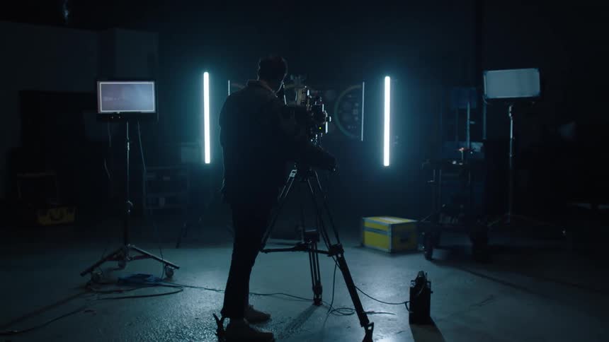 A man walks in to a room and looks in to his camera