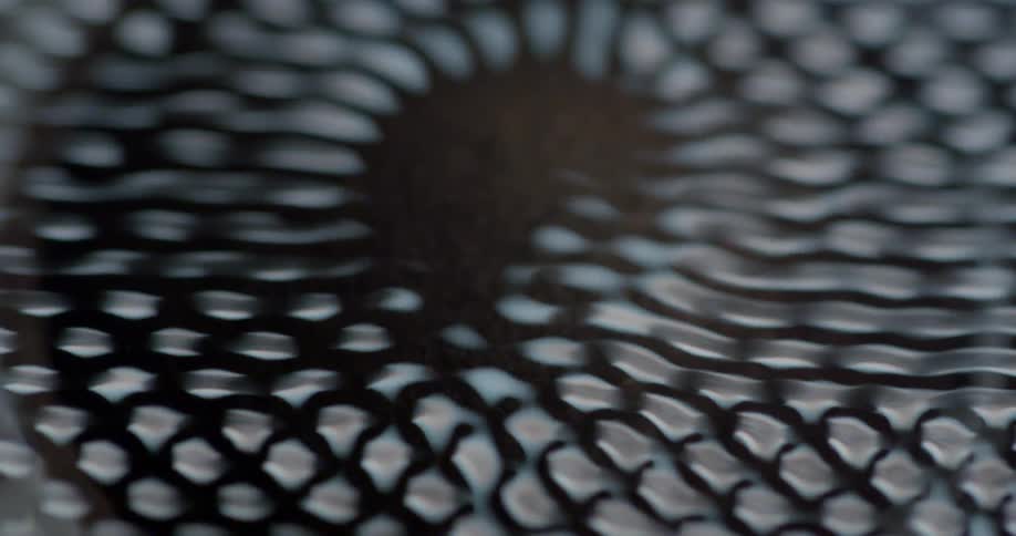 A pattern of light vibrates over a brown soil like substance