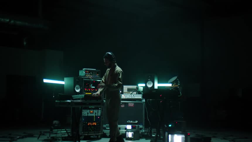 A man works with audio equipment