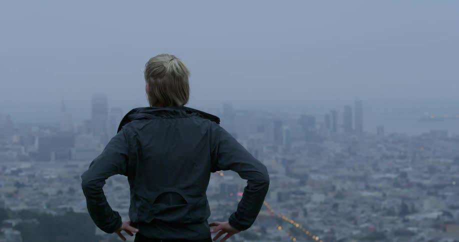 A woman is looking at a city skyline