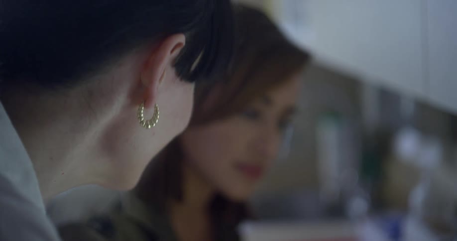 A female doctor talking to a younger female patient in a doctors office