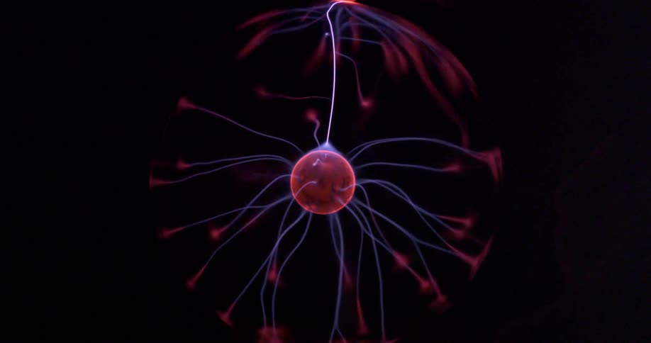 A plasma ball reacts in bright colorful beams of electricity