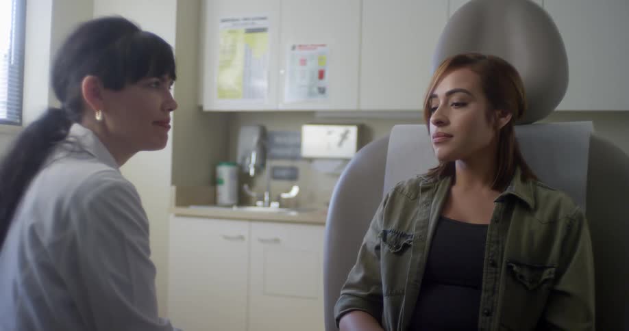 A doctor and a patient talk in an examination room at a clinic