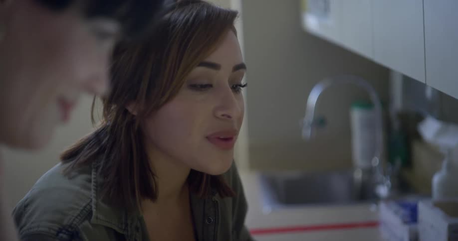 A female doctor talking with a younger woman in a doctors office