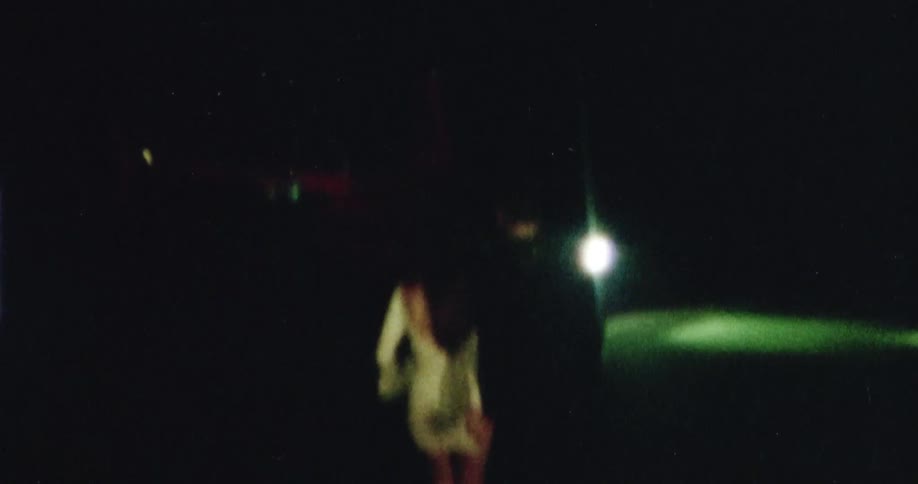 A man and a woman holding hands running towards a helicopter