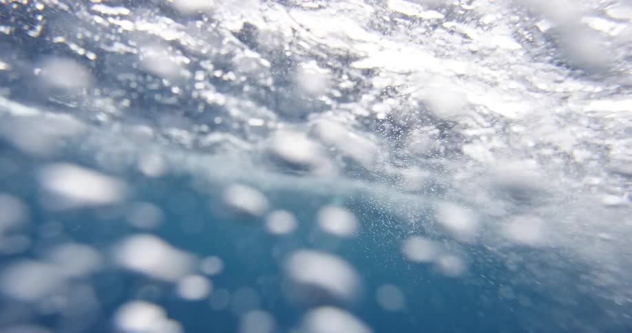 Underwater footage of a wave on clear ocean water