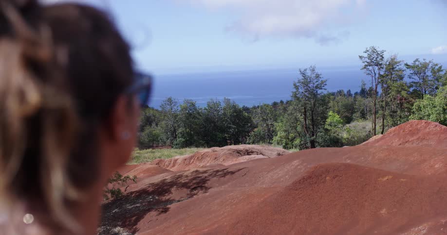 A woman looks past the hills in front of her