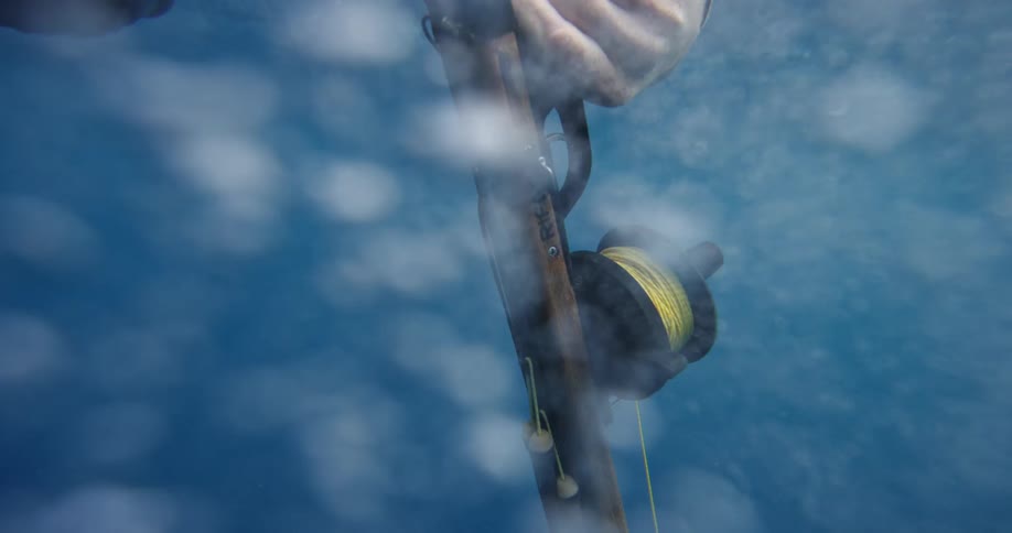 Fisherman holding a fishing rod falls into the lake