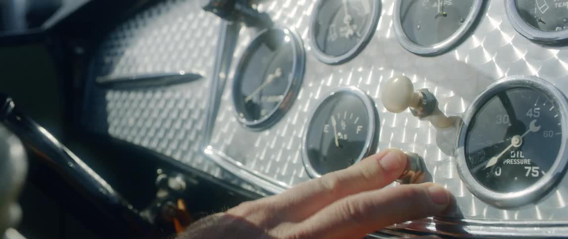 A man pushes buttons in a cockpit