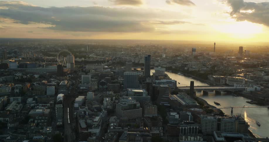 London Eye and city skyline at sunset