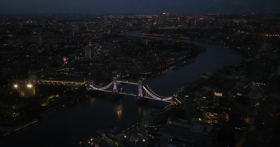 Aerial view of London Bridge with the city lit at night