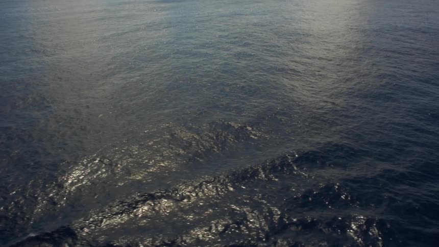 Aerial view of a body of water that is reflecting light