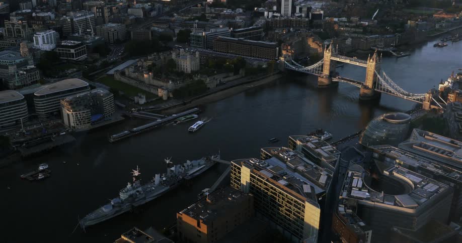 Aerial view of a bridge and boats traveling between a city