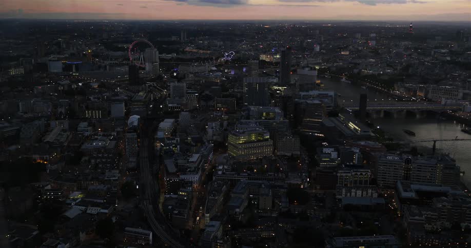 London Eye and city skyline at dusk