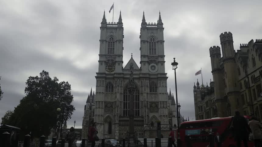 People are walking in front of Westminster Abbey cathedral