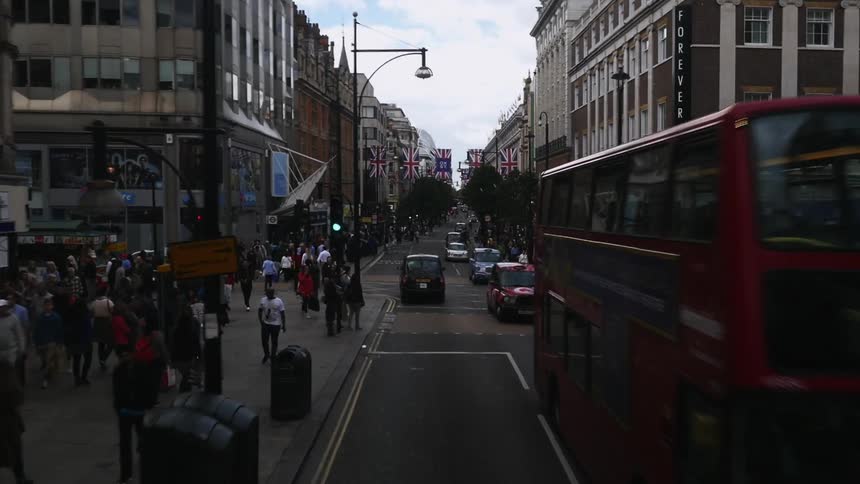 A view of a city with many people walking along the sidewalks