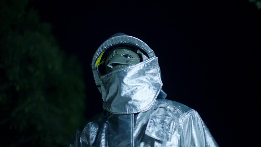 A man in a space suit as a light flashes