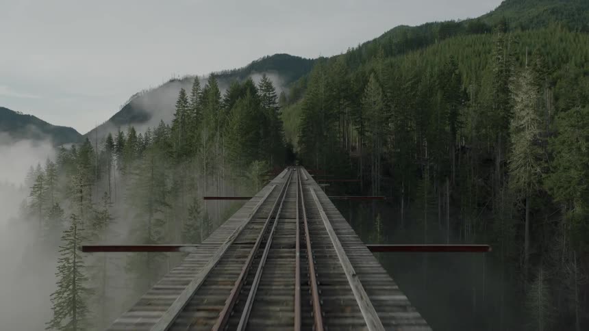 Moving over a train track on a bridge on a foggy day