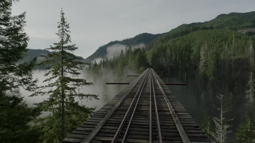 A train bridge stands in the mountains