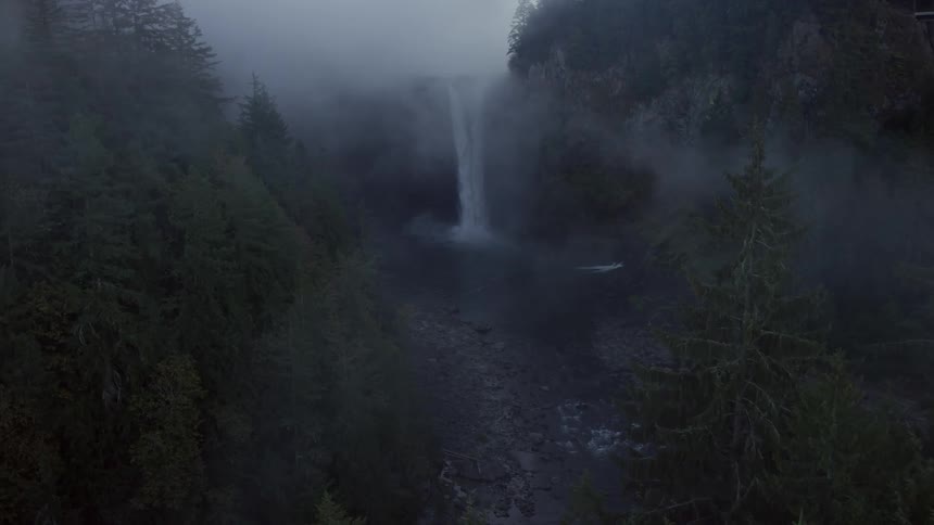 A waterfall can be seen in the distance on a cloudy day